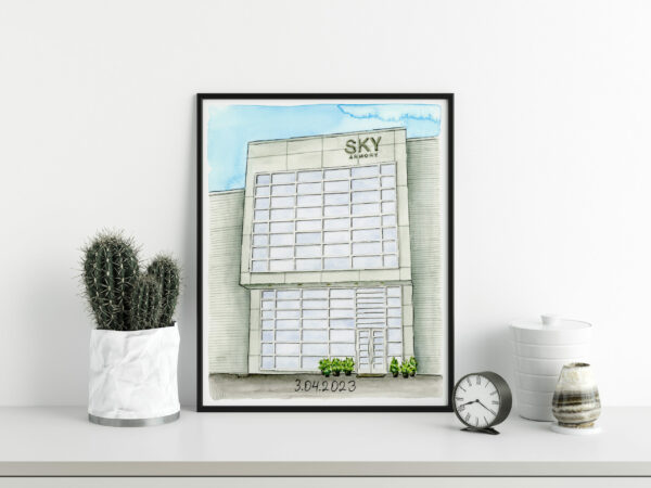 A framed watercolor painting of an industrial looking wedding venue building.